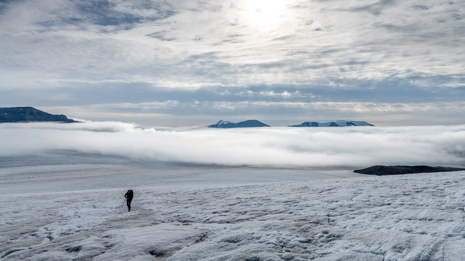 Nordenskiöldbreen glacier on Svalbard, a lone figure walking across the ice